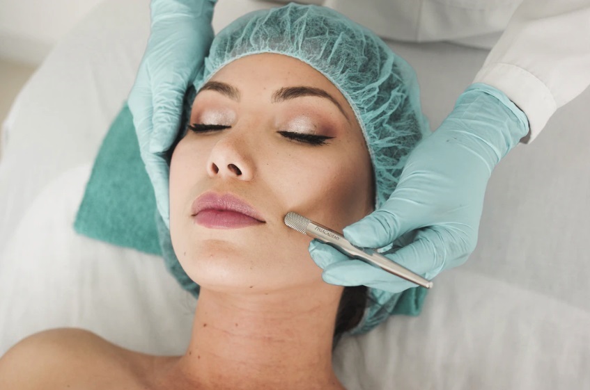 Woman receiving microneedling treatment